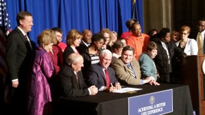 Surrounded by disability advocates and legislative sponsors Sen. Luke Kenley and Rep. Ed Clere, Gov. Mike Pence signs the Indiana ABLE Act. Indiana joins nearly 40 other states that have passed similar authorizing legislation.